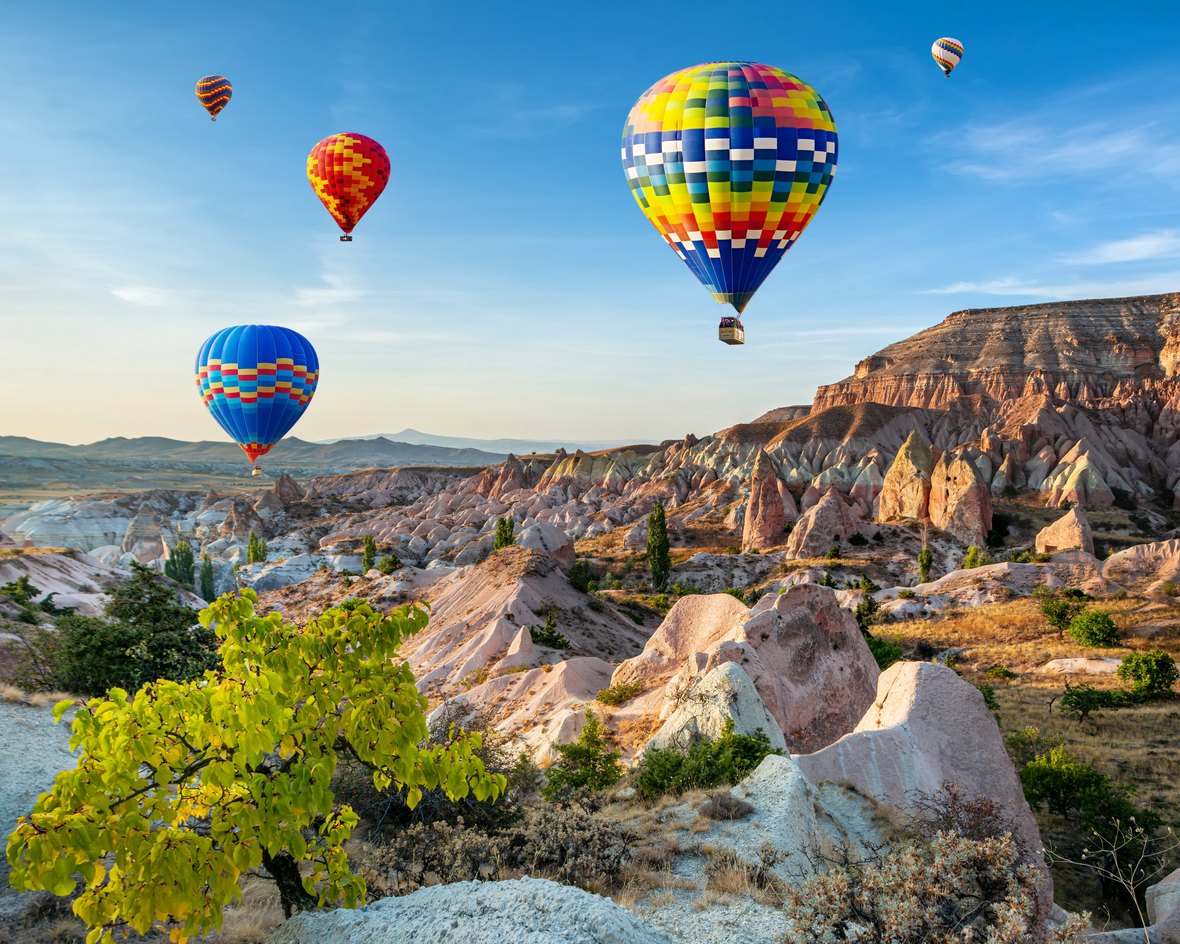Hot air balloons over mountains